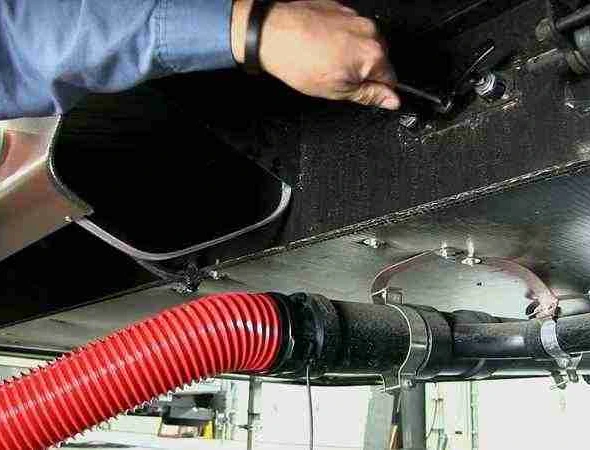 A man uses a hose to wash the inside of a vehicle, highlighting the significance of complete RV plumbing care.